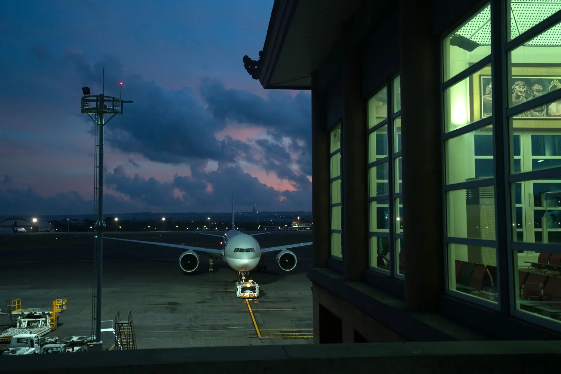Passenger aircraft at an airport gate at night